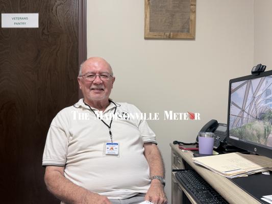 PHOTO BY RICHARD SIRMAN Paul Baker settles in at the assistant veterans service officer desk at the Madison County annex. Baker, the Robertson County VSO since 2021, will split his weeks between Hearne and Madisonville while the county fills the post left open by Erica Greene’s April resignation.