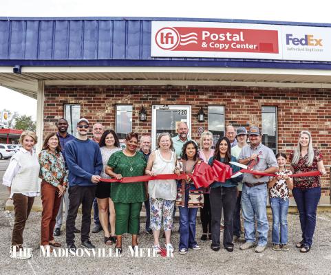 The Madison County Chamber of Commerce celebrated LFI Postal &amp; Copy Center, LLC with an official chamber ribbon cutting Wednesday, Oct. 30. Under new management and a new location, LFI offers an array of printing and postal services. The new location is located at 220 W. Trinity Street in Madisonville. METEOR PHOTO BY ANA COSINO-MIZE