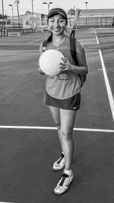 Madisonville's Shenny Rodriguez holds an oversized tennis ball after clinching the decisive 10th point in the Mustangs' 10-2 victory over Huntsville on Thursday, Aug. 15. COURTESY PHOTO