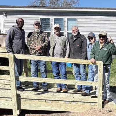 Volunteers from Madisonville First Baptist Church build a wheelchair ramp at a residence on Friday, March 13. 