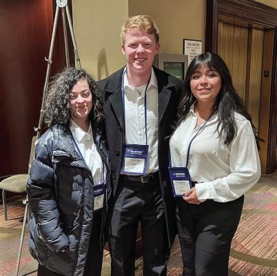 From left to right, Lorin Bastardo, Andrew Cole, and Viviana Estrada are at Carnegie Hall in New York City.