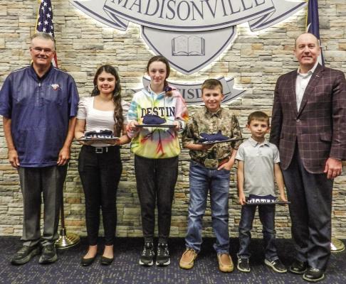 The March students of the Month are Briesly Flores Urraya (HS), Trinity Grisham (JH), Jett Bankhead (INT), and Baelon Barnes (ELEM), pictured with Dr. West and Vice President of the Board Mr. Dale Hurst. COURTESY PHOTOS