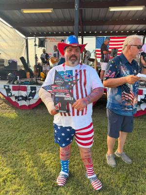 TJ Douget shows off his Most Patriotic Adult trophy at the City of Madisonville Fourth of July celebration.
