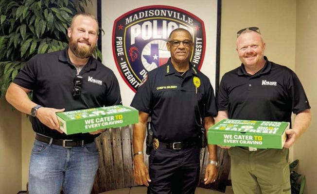 Representatives from Kramer Autoplex Madisonville stand with Madisonville Police Chief Herbert Gilbert after sharing a meal with Gilbert and his team on Friday, April 24.  