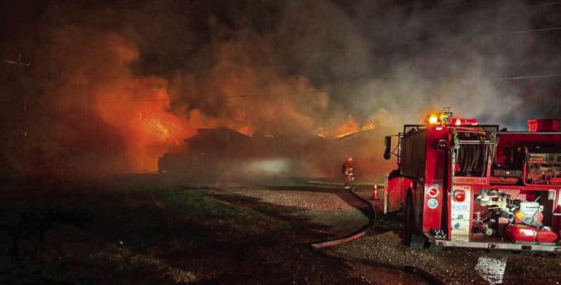 Firefighters battle the blaze at Trooper Jaime Iniguez’s home in Bedias on Feb. 16. The fire destroyed the residence while Iniguez was deployed to the State Capitol. COURTESY PHOTOS