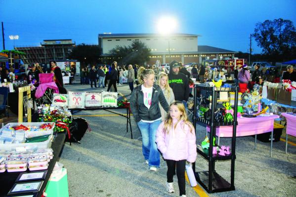 METEOR PHOTOS BY RICHARD SIRMAN Families browse vendor booths and enjoy train rides at Winterfest on Monday, Dec. 15 in the Madisonville High School parking lot. The Mustang Band fundraiser featured food trucks, an ornament workshop, bounce house and live Christmas music.