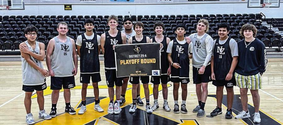 The North Zulch boys basketball team holding up a sign stating that they’re playoff bound