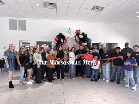 Members of the Madison County Chamber of Commerce join the Amaya family and staff for a ribbon cutting at Nelson Amaya’s Collision Center, which opened its new location at 201 N. May St. Friday, May 29.