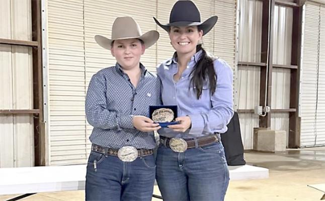 Reygan Farris Richardson (right) being presented the top prize trophy by Mason Miller (left)