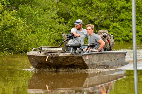 Zack Kelly and Nick Hahn idle for the next Caney Creek water taxi run. 