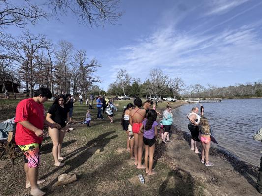 Swimmers brave the brisk Lake Sullivan waters during Fort Boggy State Park's second annual Get Froggy plunge Jan. 1. Water temperatures hovered around 60 degrees for the New Year’s Day dip PHOTOS COURTESY OF FORT BOGGY STATE PARK
