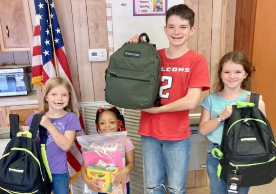 Hannah Leland, Autumn Ford, Jeremiah Leland and /Tabitha Leland show off school supplies earned with their participating in Midway’s Summer Reading Program. Hannah Leland, Autumn Ford, Jeremiah Leland, Tabitha Leland stand with