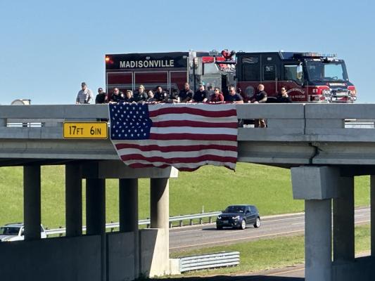 Local law enforcement and first responders paid tribute to fallen Deputy Sheriff Charles Rivette as his procession drove through Madison County. METEOR PHOTO BY RICHARD SIRMAN