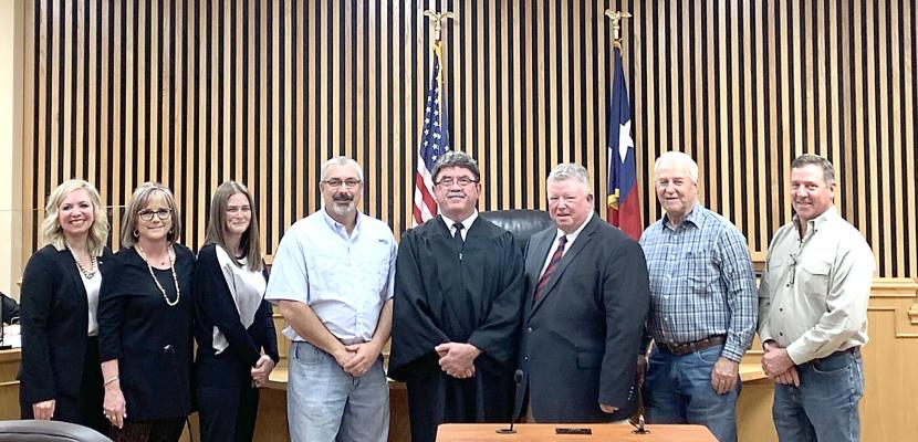 Pictured at the County Courtroom in the Annex Building in Madisonville, from left to right; Courtney Cain, Rhonda Savage, Adrian Lawson, Jon Stevens, Clark Osborne, Steven Cole, Carl Wiseman, David Pohorelsky