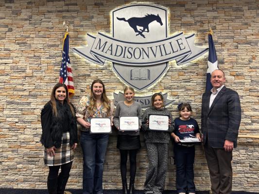  Students of the month for January hold their certificates during the Madisonville Consolidated Independent School District board meeting Monday, Jan. 12. Pictured are board member Randi Pipes (left), Madison Perry, Addyson Tobias, Jeulianna Hernandez, Audrey Cupit and Board President Dale Hurst.