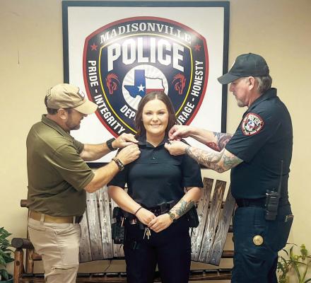 Former Lt. Keith Bitz (left) and former Capt. Richard Morris pinned a captain’s insignia on Brittney Mahler at the Madisonville Police Department. COURTESY PHOTO