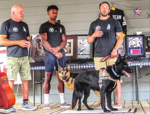 Army Staff Sergeant Charles Bischoff with K9 Mandalorian (Mando) addresses attendees at the Rebuilding Warriors fundraiser Sunday, June 5. FILE PHOTO