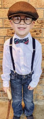 Madisonville Elementary kindergartener Aiden stands dressed as a dapper 100-year-old gentleman, complete with suspenders, bow tie, newsboy cap and walking cane during the school's 100th day celebration Jan. 30. COURTESY PHOTO