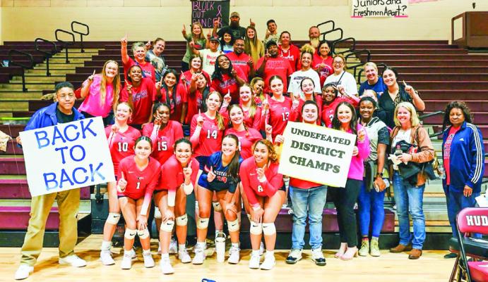 The Madisonville Lady Mustangs volleyball team celebrates their undefeated district championship following their 3-1 victory at Hudson Oct. 29. COURTESY PHOTO O