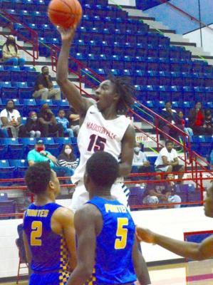 (Right) Wayne Roundtree goes up for a basket during the Mustangs’ upset win, in which he led the team with 19 points. CAMPBELL ATKINS