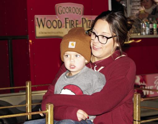 A mother and son take a train ride at the Mustang Band's Winterfest fundraiser on Monday, Dec. 15 in the Madisonville High School parking lot. METEOR PHOTO BY RICHARD SIRMAN