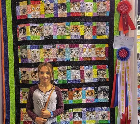 Autumn Smith with her award-winning “Cats Eyes” quilt