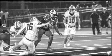 Madisonville senior linebacker Connor Swonke attempts to jar the ball loose from Navasota running back Jamall Thomas. Madisonville prevailed 26-16 in the rivalry game.
