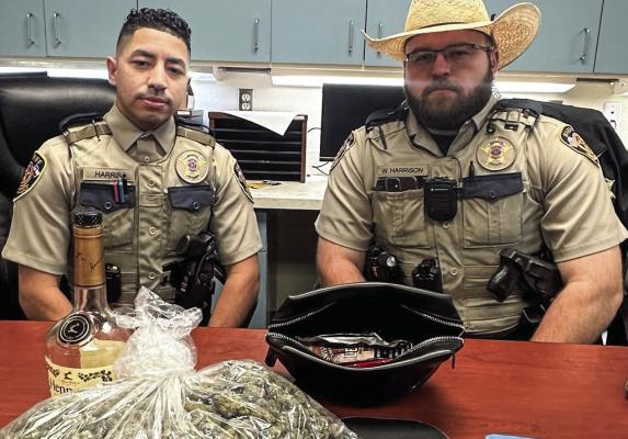 Deputy Harris and Deputy Harrison with the confiscated items from the arrest.