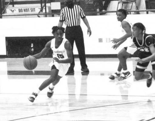 Madisonville’s Wayne Roundtree dribbles around Connally defenders at the top of the key in the team’s home loss at MHS Jan. 19. CAMPBELL ATKINS
