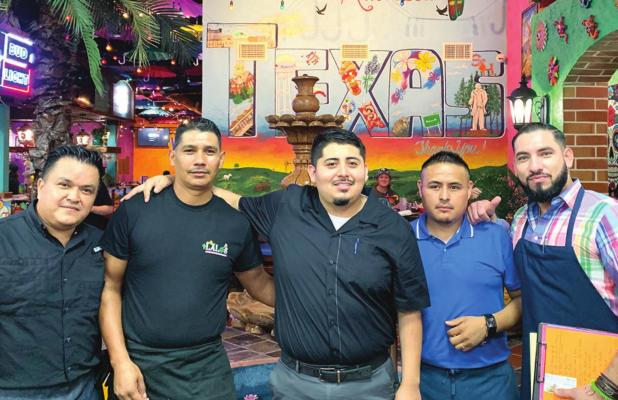 In front of the fountain and mural inside the restaurant some of the managers of Lalo’s Mexican Grill, Luis Avalos, Antonio Alvarez Morales, Alejandro Arellano Ramirez, Javier Cujano, Jose Enriquez