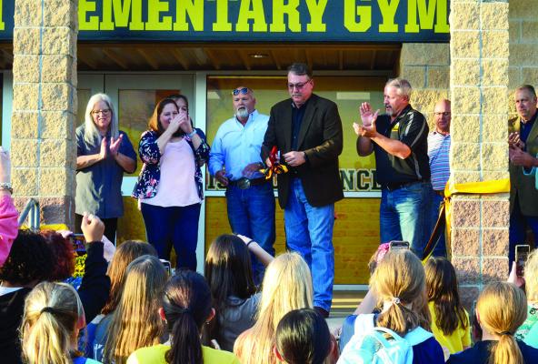 Karl Radde cutting the ribbon at the construction site at North Zulch ISD.