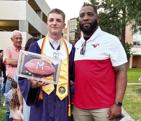 Madisonville High School quarterback Ty Williams (left) poses with offensive coordinator Brad Taylor following graduation ceremonies Thursday at Sam Houston State University. Williams holds six school passing records after throwing for 5,539 yards and 65 touchdowns during his career. PHOTO COURTESY OF COACH BRAD TAYLOR