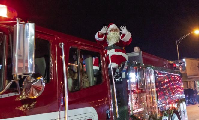 Santa Claus waves from a fire truck during the Nutcracker Christmas on Main Street Parade in downtown Madisonville Saturday, Dec. 7. METEOR PHOTOS BY CELESTE ANGUIANO