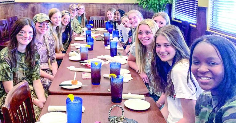 The Lady Mustangs Volleyball team on camo day for homecoming at Texas Legends Steakhouse; Homecoming King Coy Alvarado and Homecoming Queen Grayson Bennett; The Class of 1977 in front of the Madison County Courthouse for their class reunion picture