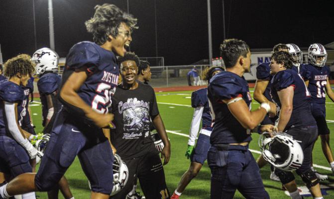 Madisonville Mustang Sovannattra Ly (28) celebrates with teammates following their overtime victory against Navasota on Friday night at Mustang Stadium. METEOR PHOTOS BY RICHARD SIRMAN