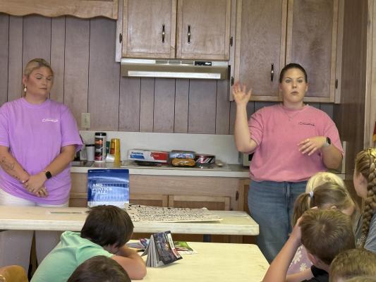 Brazos Valley Food Bank staff teach children how to make trail mix and hand out food bags during the third Friday of the Midway summer reading program at City Hall. The visit was part of the food bank's Kids in the Kitchen series running through July.