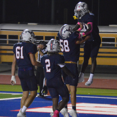 Mustang Kyus Ford (#4) hoisted in the air after scoring.
