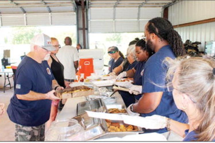 Families gather to eat and children play during the Midway Volunteer Fire Department fish fry and fireworks show Saturday, June 27, at the Midway fire station on School Road. The free event raised money for the all-volunteer department. METEOR PHOTOS BY RICHARD SIRMAN