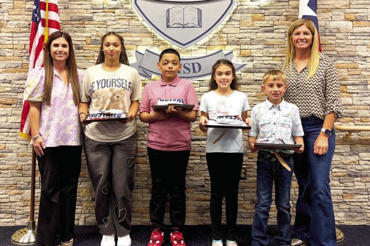 Madisonville Consolidated Independent School District board members Randi Pipes (left) and Quincy Allen (right) stand with May Students of the Month Char’Lecia Holland (high school), Alejandro Cisneros-Delgado (junior high), Molly Gaskins (intermediate) and Jozey Rahmn (elementary). COURTESY PHOTOS