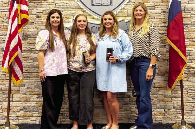 Madisonville Consolidated Independent School District board member Randi Pipes (left) and board member Quincy Allen (right) recognize May Employees of the Month Kandace Upchurch and Katie Hooks, both from the elementary campus.