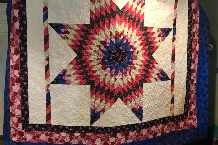 PHOTO COURTESY OF MADISON COUNTY MUSEUM A star-pattern quilt hand-stitched by Georgia Taylor hangs on display at the Madison County Museum, where it anchors a raffle running through Oct. 21. The museum, open 10 a.m. to 2 p.m. Wednesday through Saturday at 201 N. Madison St., is selling raffle tickets for the quilt — $1 each or six for $5. Tickets are available at the museum and from others helping with the sale.