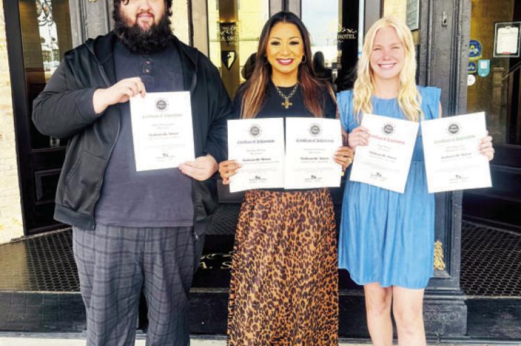 Madisonville Meteor editor Richard Sirman, Growth and Development Executive Ana Cosino-Mize and Community Marketing Consultant Alexis Morgan hold the paper’s certificates from the 2025 Texas Better Newspaper Contest. PHOTO BY CELESTE ANGUIANO