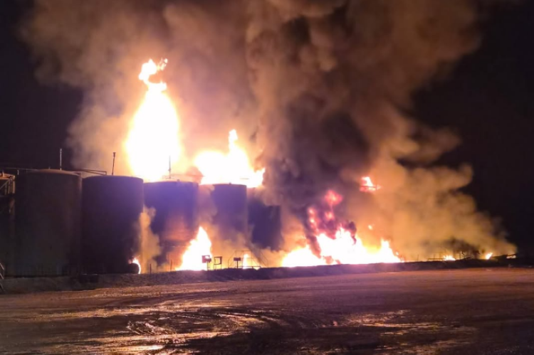 Flames reach high as fire crews from six departments work to contain the blaze.