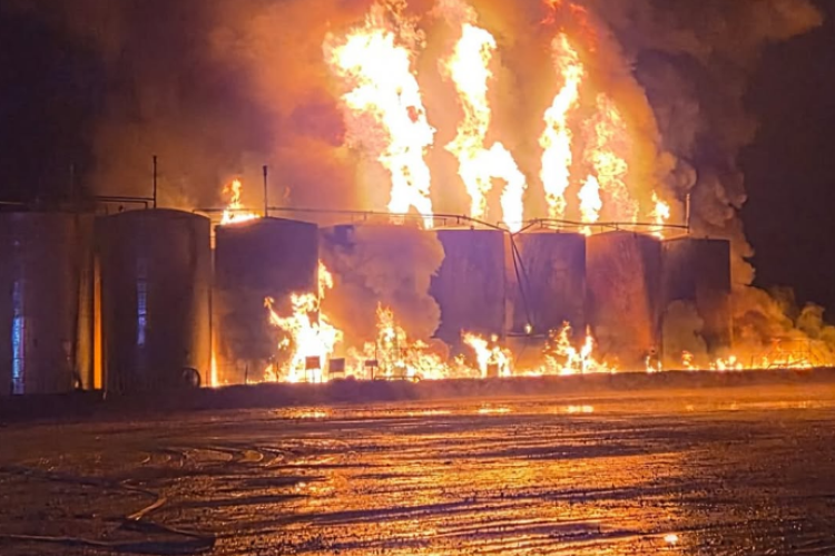 Condensate tanks burn after a lightning strike ignites the flammable natural gas byproduct on FM 1452 West Thursday. PHOTOS COURTESY OF NORTH ZULCH VOLUNTEER FIRE DEPARTMENT