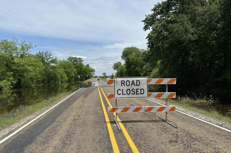 The road closed sign on Farm to Market 2548 on Friday, May 17, following flooding from the previous night’s storms. METEOR PHOTO BY RICHARD SIRMAN