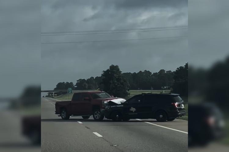 A maroon truck pushes a Texas Department of Public Safety trooper’s vehicle backward on Interstate 45 near mile marker 163 in Leon County June 29. A trooper shot the suspect, who was airlifted to a Temple hospital in critical condition. PHOTO COURTESY OF GRACE DELA CRUZ